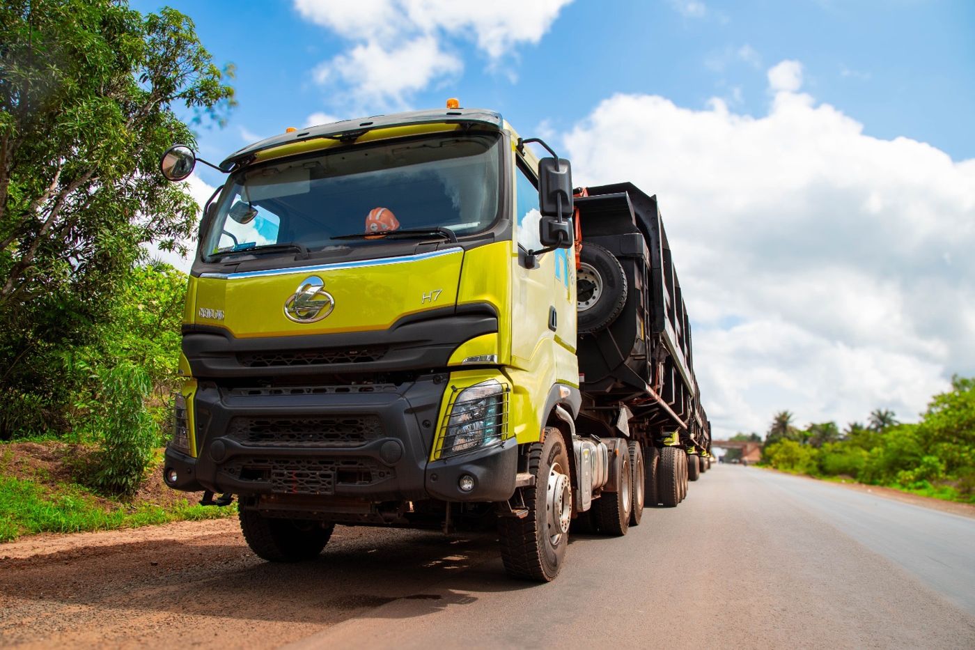 Tracteur routier SPL garé au bord de la route, la file de camions derrière